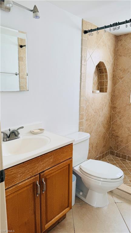 Bathroom featuring a single vanity with wood cabinetry, a white basin, and a chrome faucet