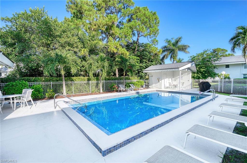 Rectangular swimming pool with tiled coping and white deck surround