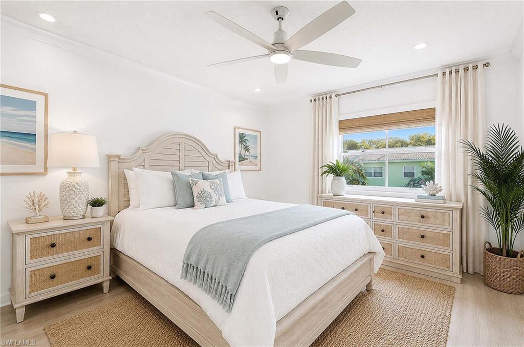 Virtual Renovation: Recessed lighting illuminates the ceiling fan and light wood-finish flooring