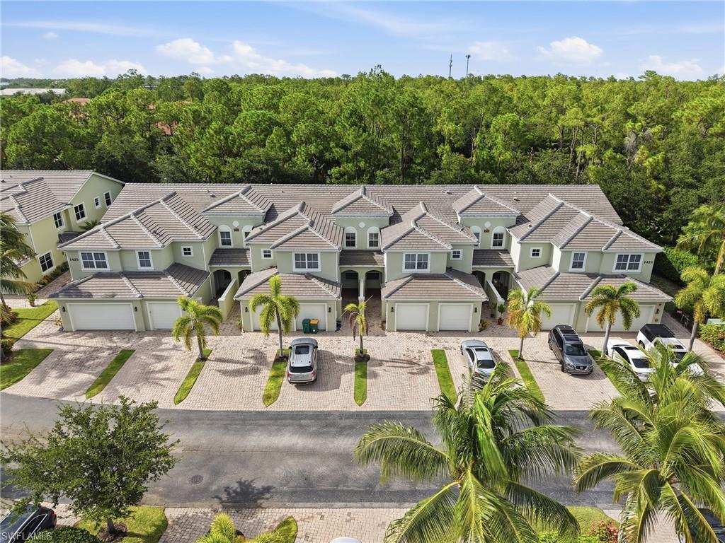 Aerial view of building with attached garages with individual paver driveways