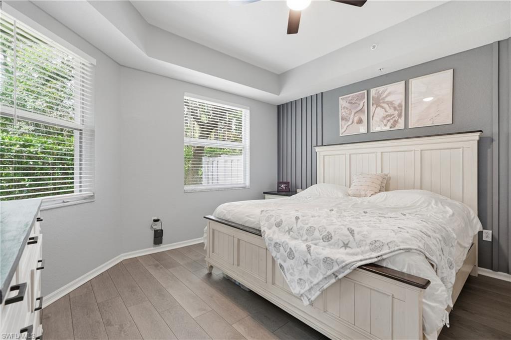 Wood-finish flooring, ceiling fan, Double doors and window with horizontal blinds