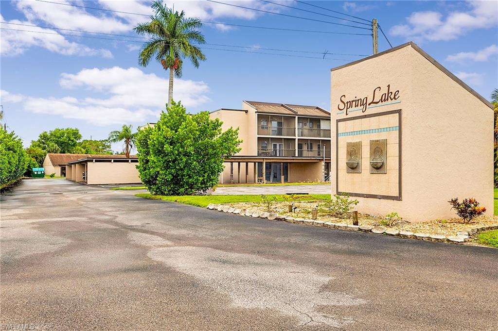 Spring Lake community entrance featuring a stucco sign with decorative tilework and dual bronze accents