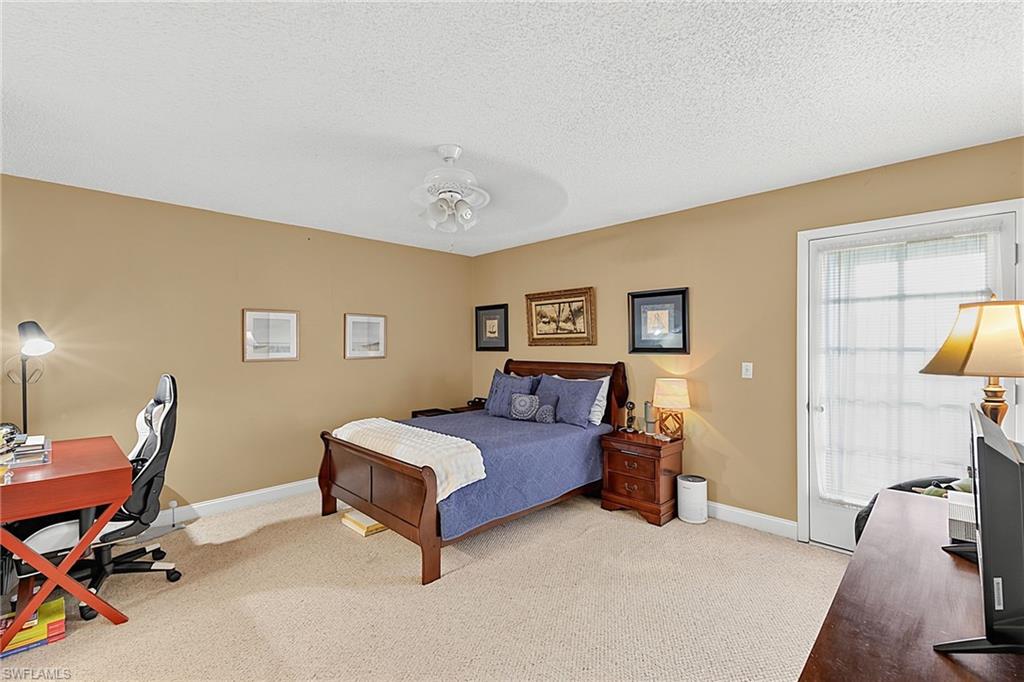 Carpeted room with neutral-toned walls and crown molding