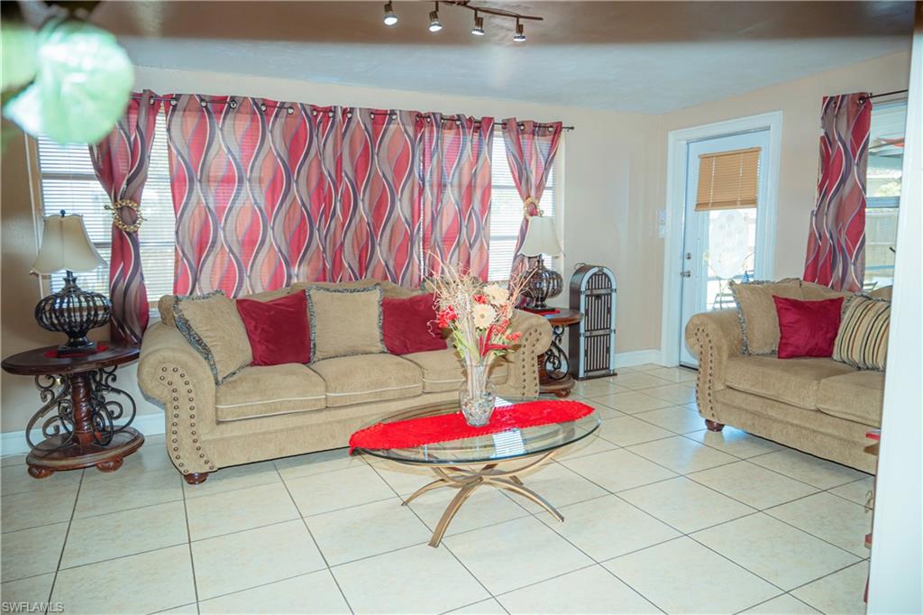 Tile flooring, multiple windows, and track lighting