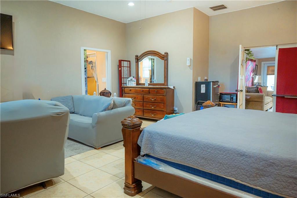Vaulted ceilings, tile flooring, and neutral wall tones