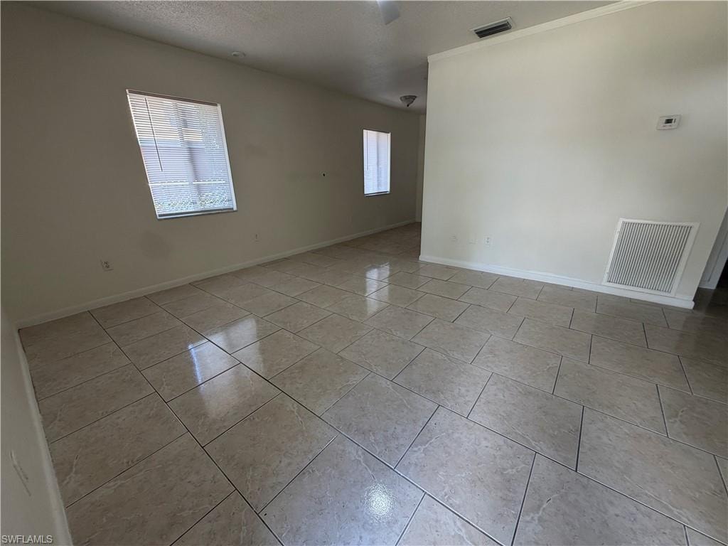 Spacious interior with tile flooring and multiple windows