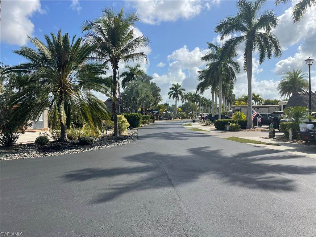 View of asphalt road with street lights