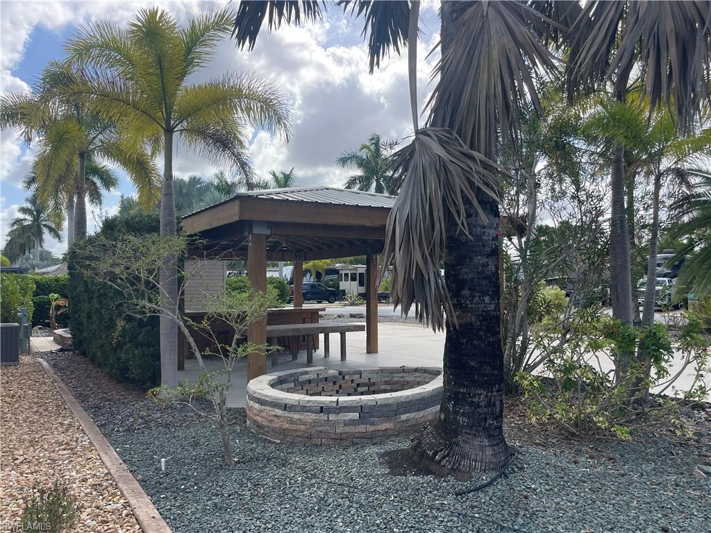 View of property's community featuring a patio area and a fire pit