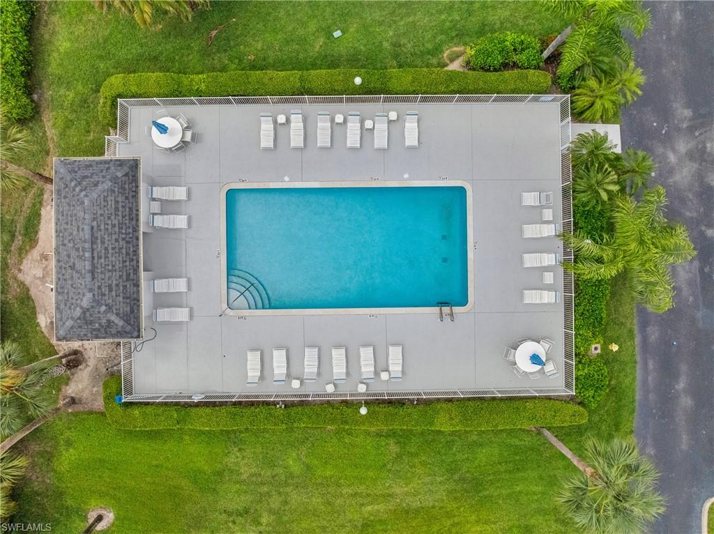 Rectangular swimming pool with integrated steps, surrounded by a paved deck