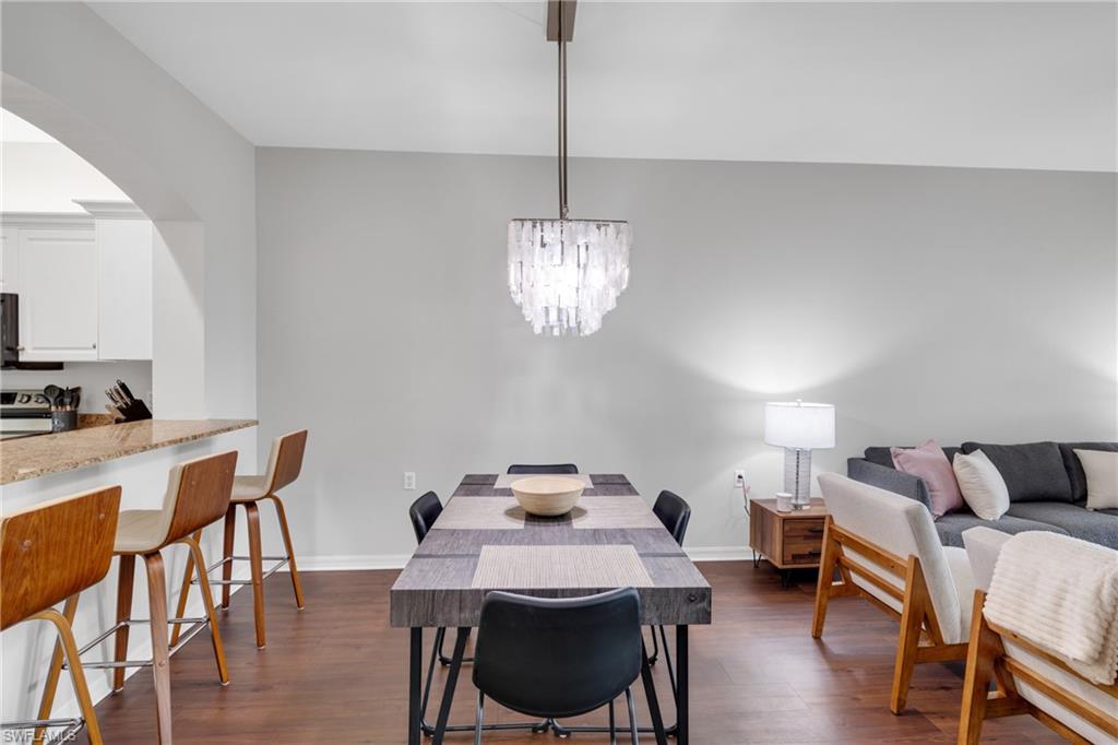 Hardwood-finish flooring, recessed lighting, and a modern chandelier