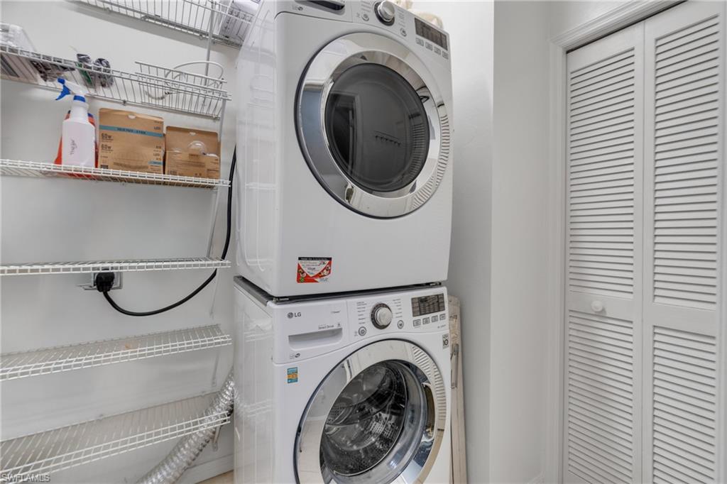 Stackable washer and dryer appliances with wire shelving and bi-fold louvered doors