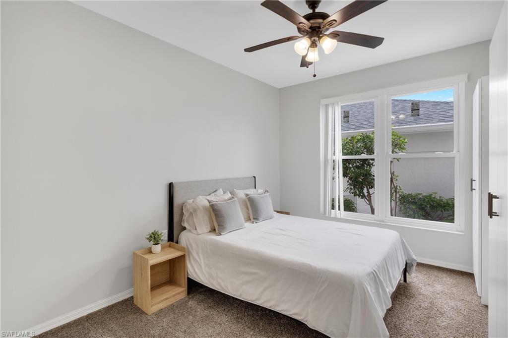 Recessed lighting, ceiling fan, white wall paint, carpet flooring, and white window frames