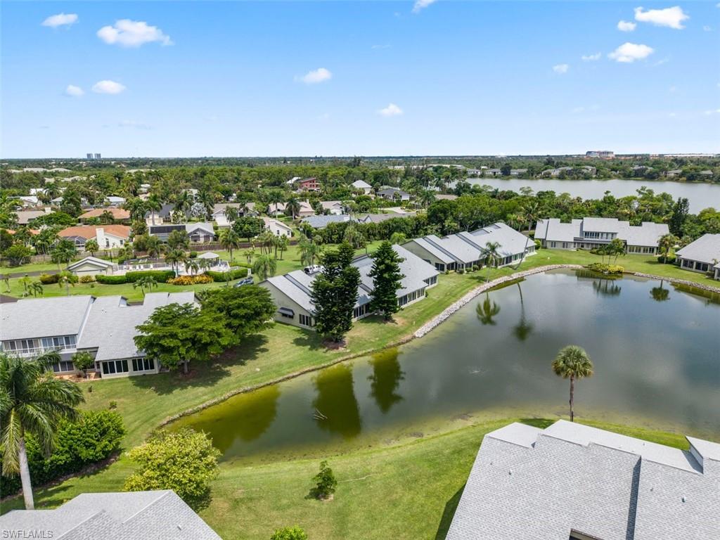 Lakeside properties featuring mature landscaping and a serene water feature