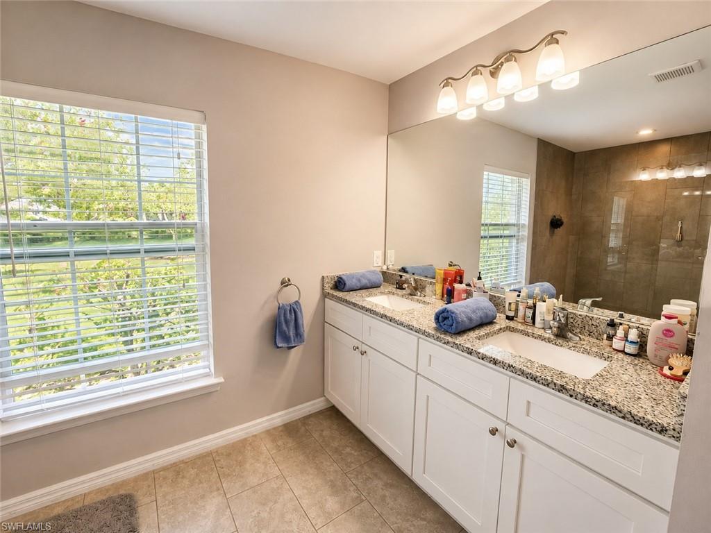 Dual undermount sinks with granite countertops and white cabinetry