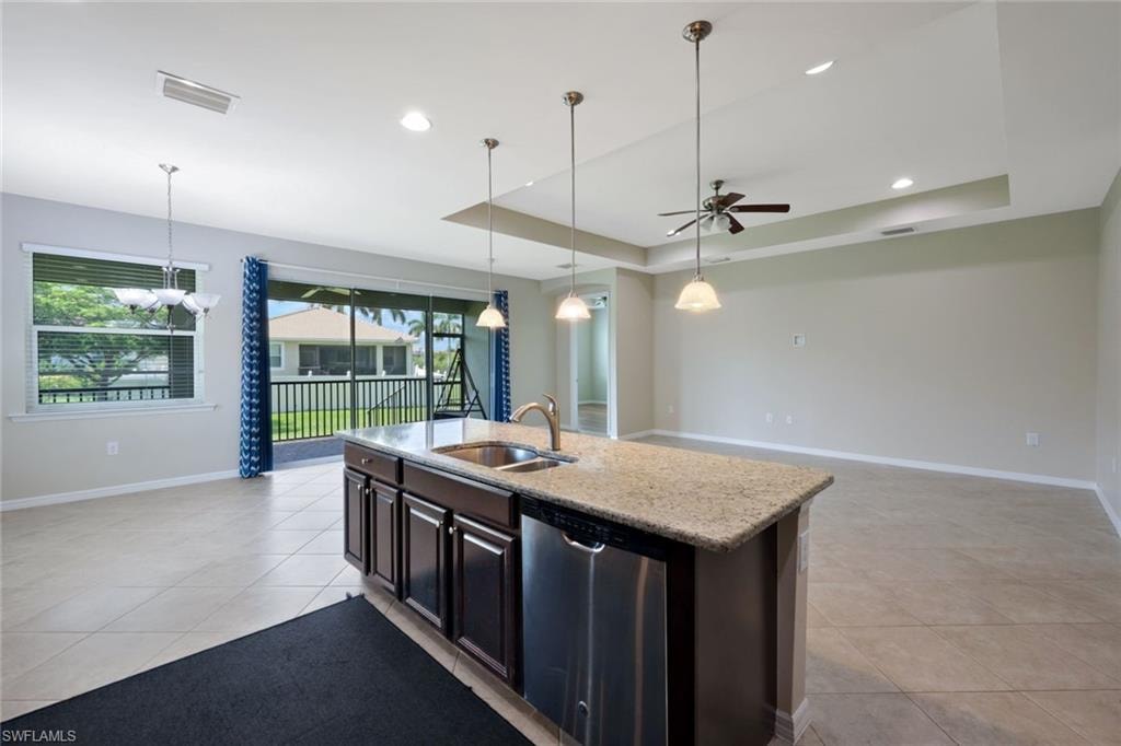 Kitchen island with a built-in sink and stainless steel dishwasher