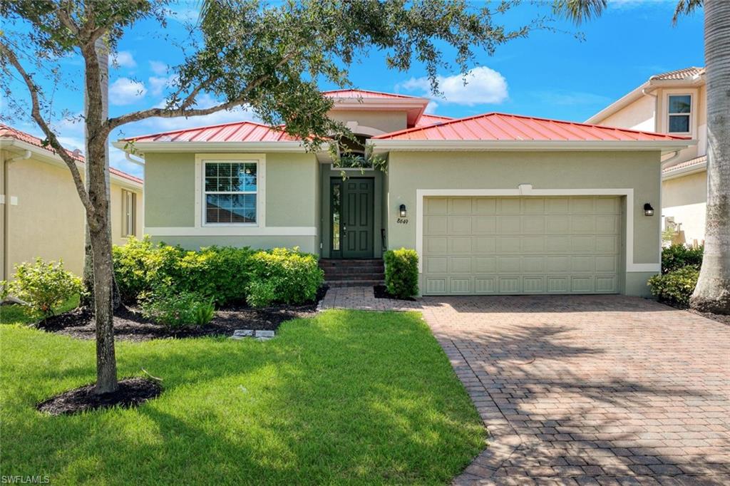 Light green exterior with a contrasting red tile roof and white trim