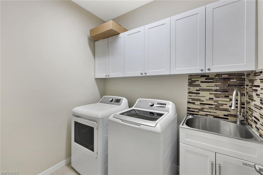 White shaker-style cabinetry, mosaic tile backsplash, stainless steel utility sink, and a chrome gooseneck faucet