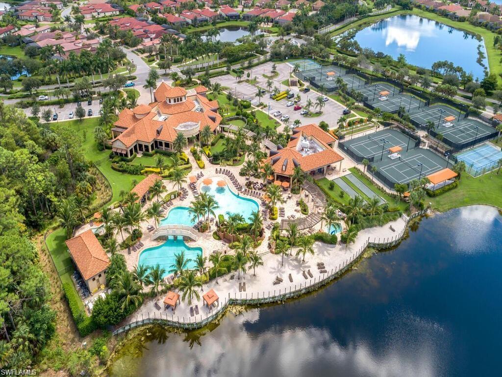 Aerial view of property's location with a nearby body of water and nearby suburban area