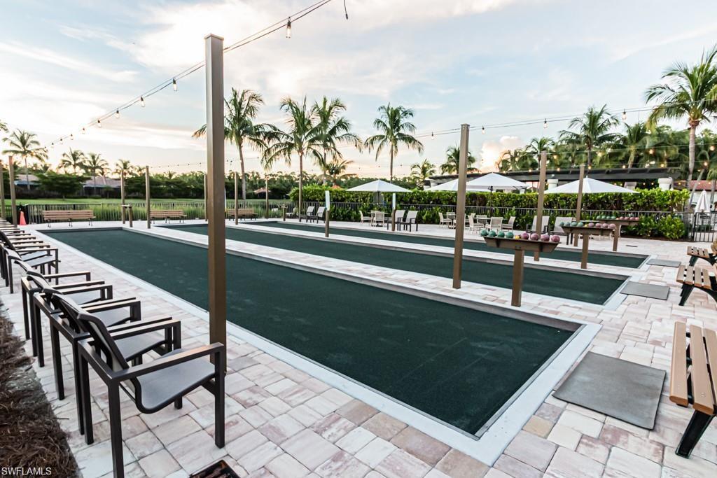 View of property's community with a bocce ball area and a patio