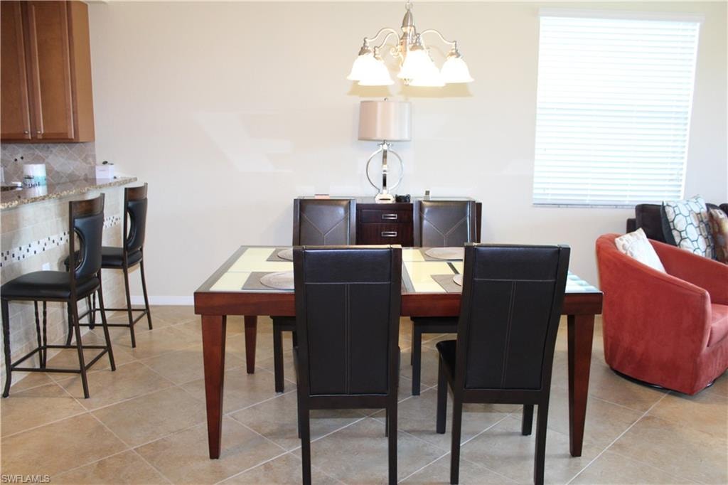 Dining area with a chandelier and light tile patterned floors