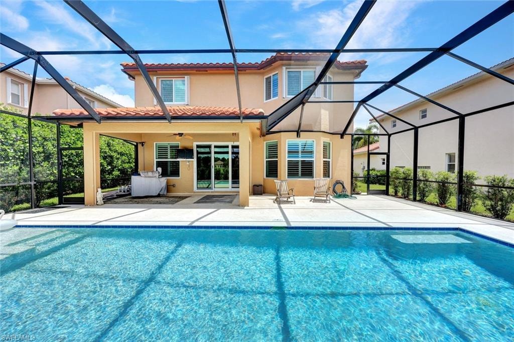 Screened-in outdoor living space featuring a swimming pool and a covered lanai