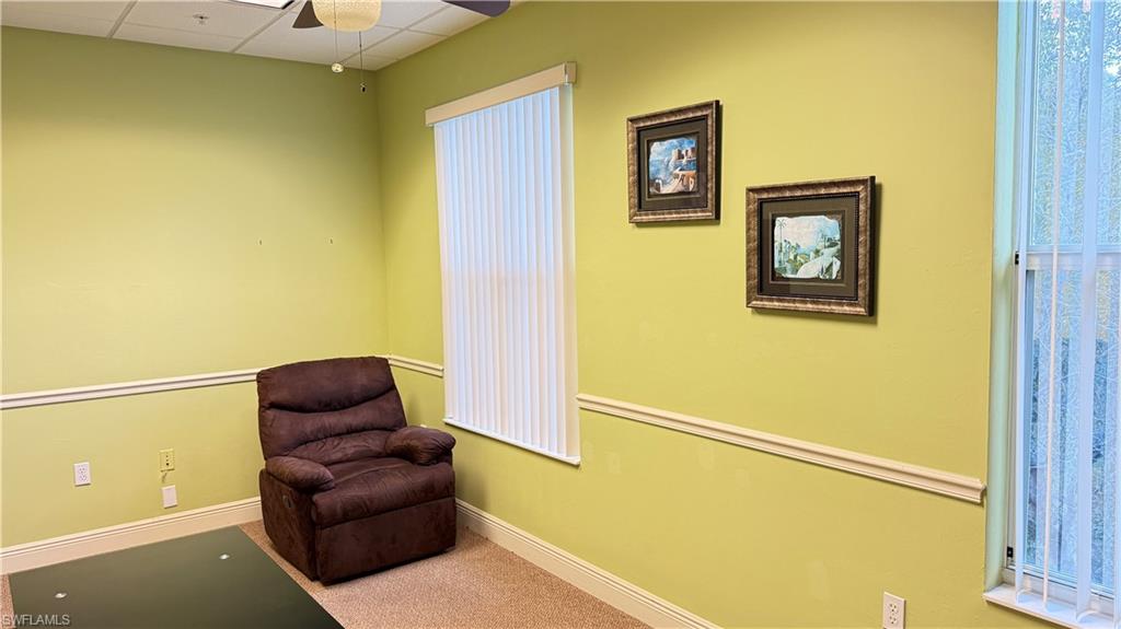 office #2 area featuring light colored carpet, a drop ceiling, and a ceiling fan