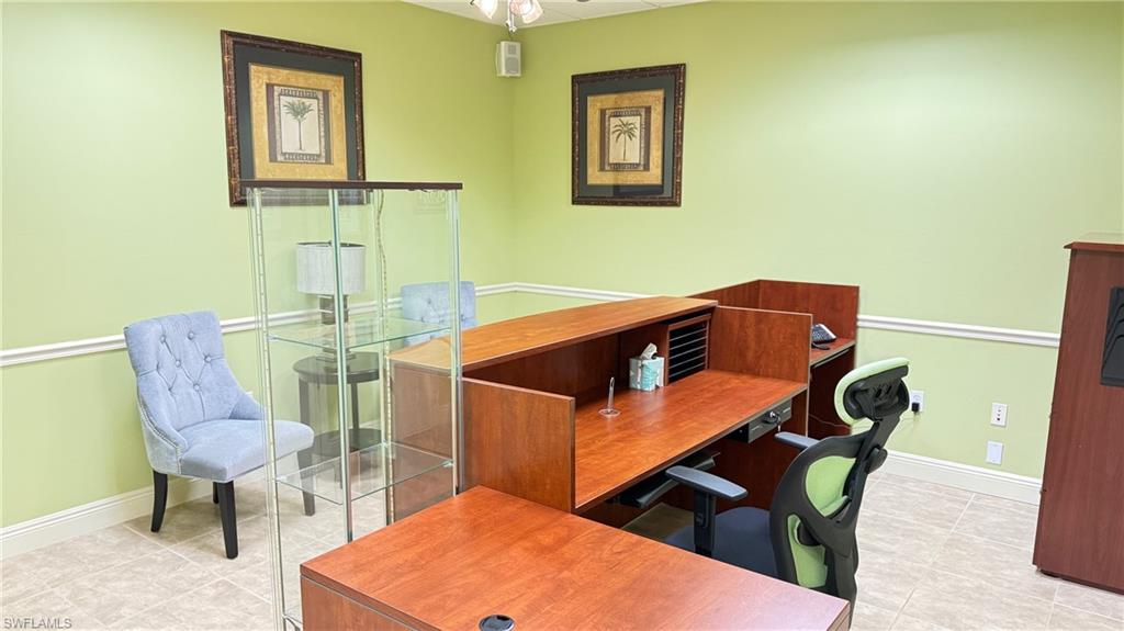 Reception area featuring receptionist desk, baseboards and light tile patterned floors