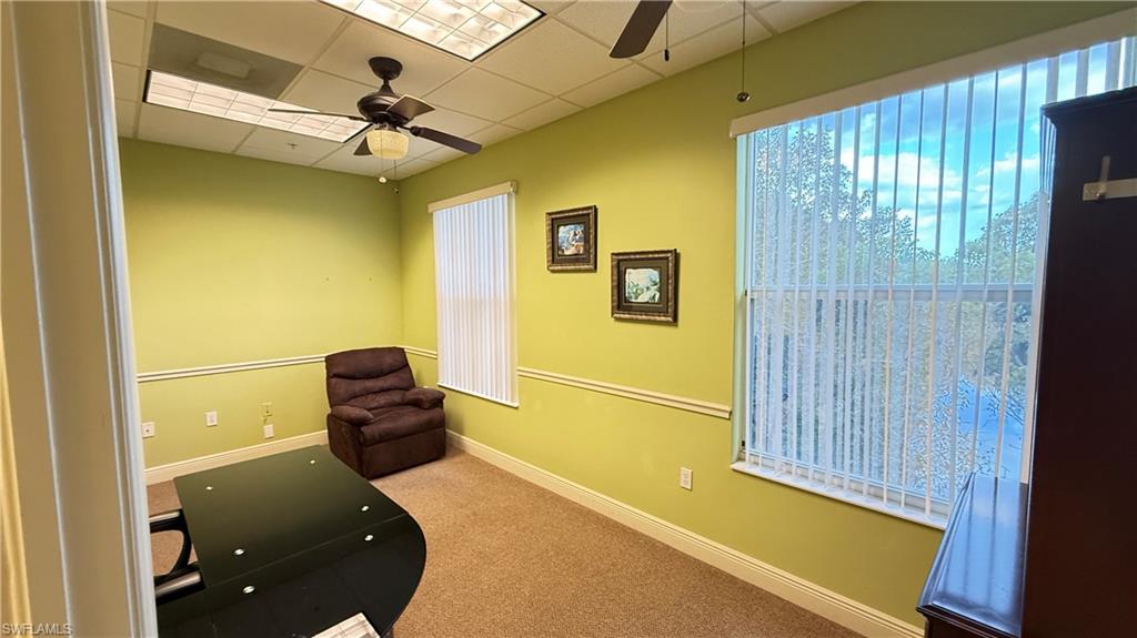 office #2 with ceiling fan, light carpet, a paneled ceiling, and healthy amount of natural light