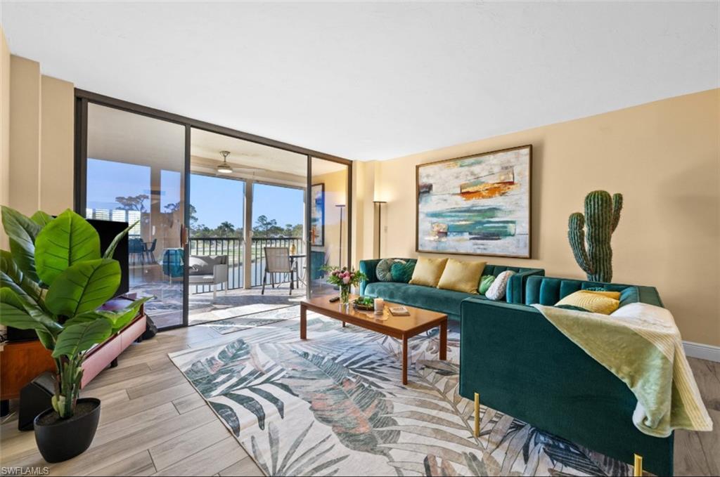 Expansive glass sliding doors open to a balcony with metal railings