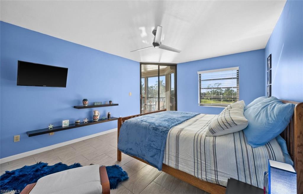 Recessed lighting, ceiling fan, built-in shelving, tile flooring, and sliding glass doors to outdoor space