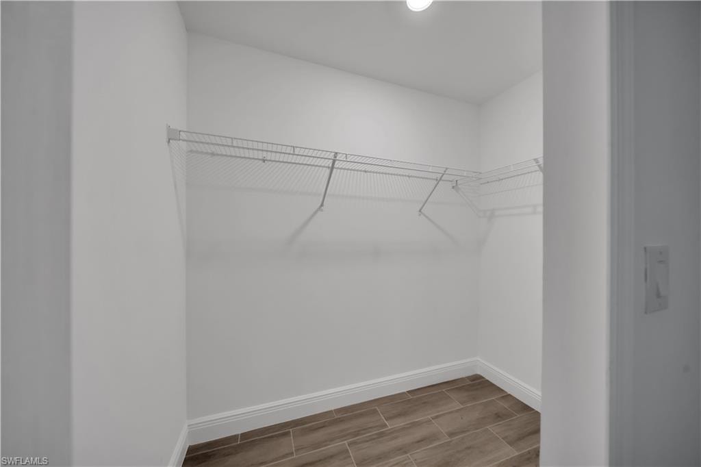 Crisp white walls, neutral wood-finish flooring, and wire shelving
