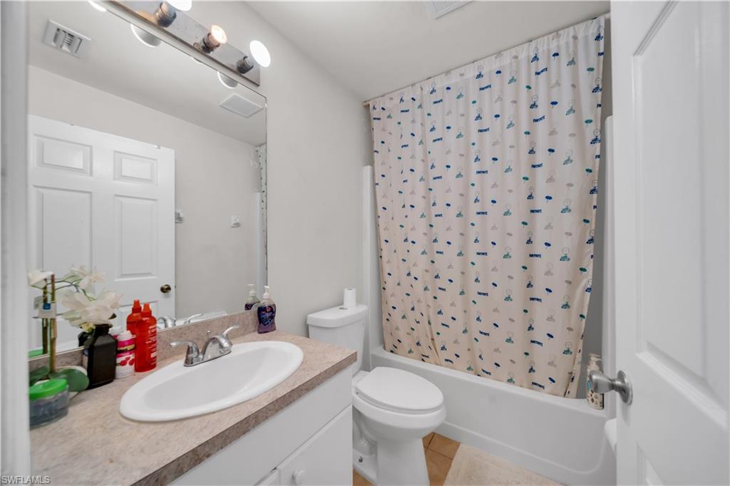 Vanity with an integrated sink, polished chrome faucet, and a large mirror