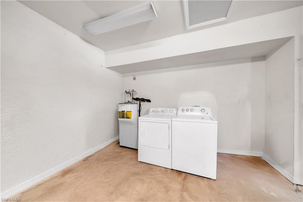 Laundry area featuring a washer, dryer, and water heater