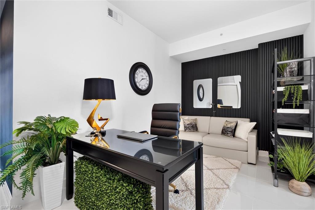 Black accent wall with vertical paneling, light-colored flooring, and recessed ceiling lights