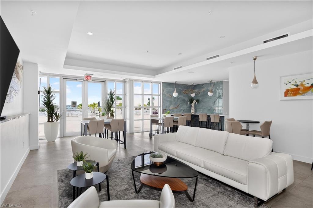 Spacious interior with high ceilings, recessed lighting, and large glass-paneled doors