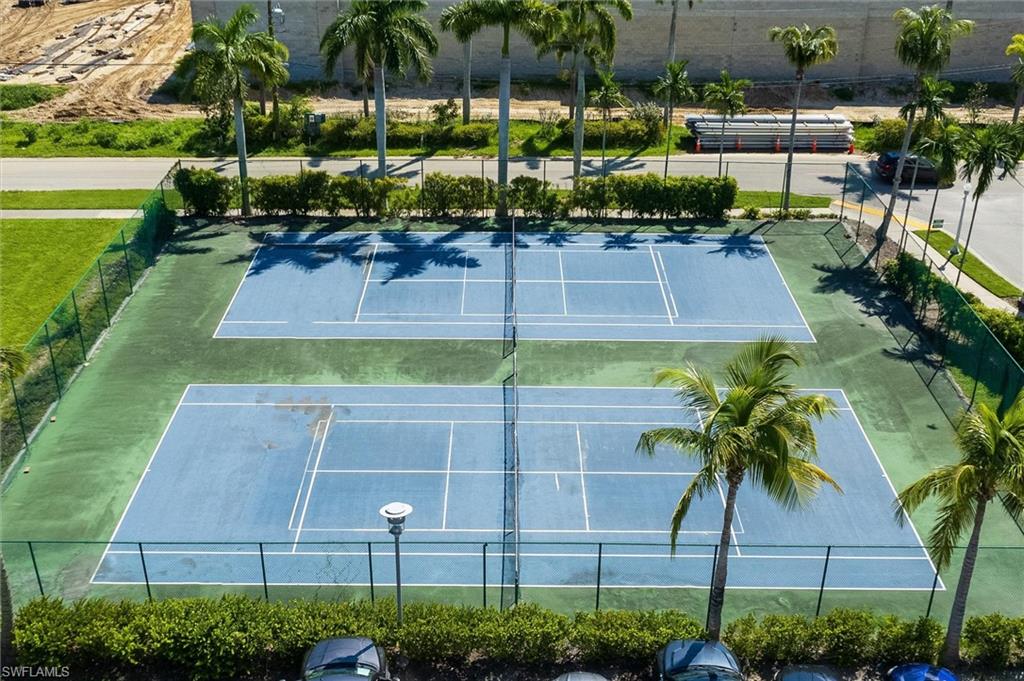 Two outdoor tennis courts with blue playing surfaces and white line markings