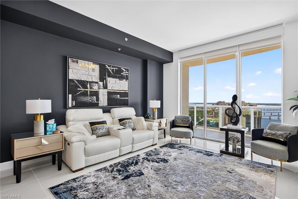 Full-height sliding glass doors, smooth ceilings, recessed lighting, and tile flooring