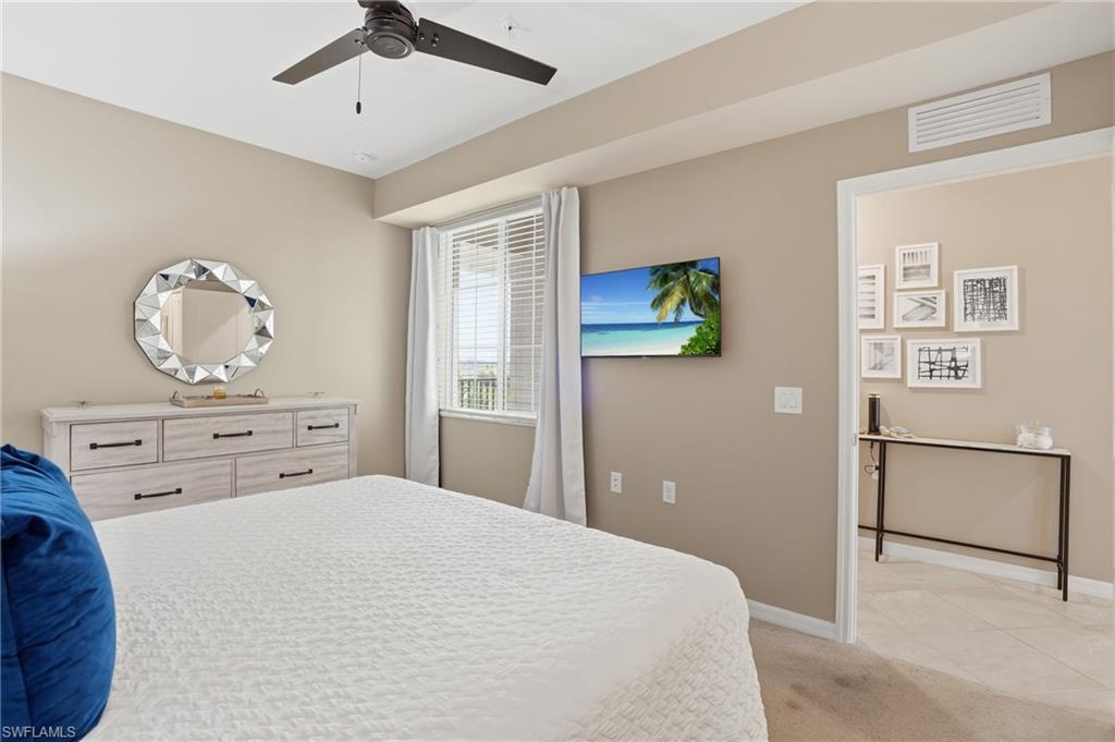 Wall-mounted television and ceiling fan enhance the space