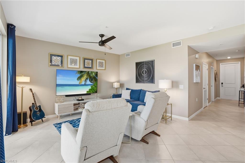 Recessed lighting, ceiling fan, neutral wall tones, tiled flooring, and paneled interior doors