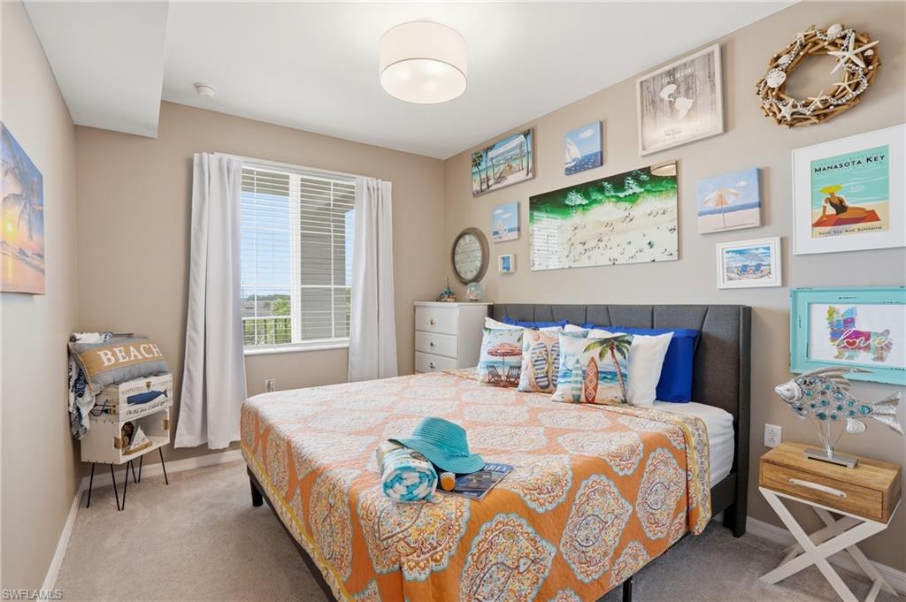 Bedroom featuring a window with blinds, carpeted flooring, and a flush-mount ceiling light
