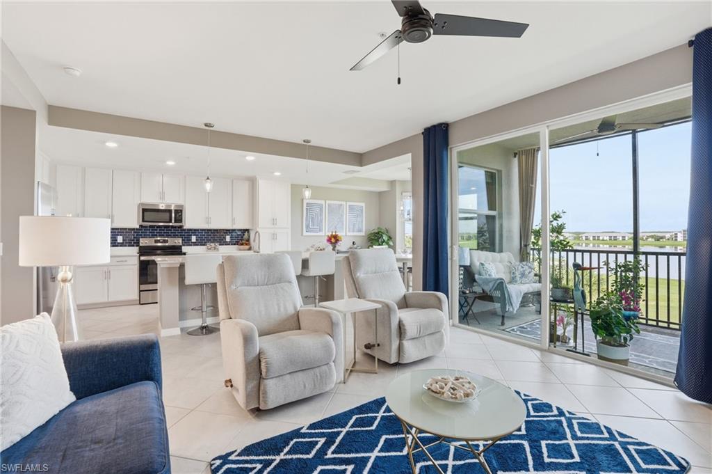 Open-concept living area with tile flooring and a ceiling fan