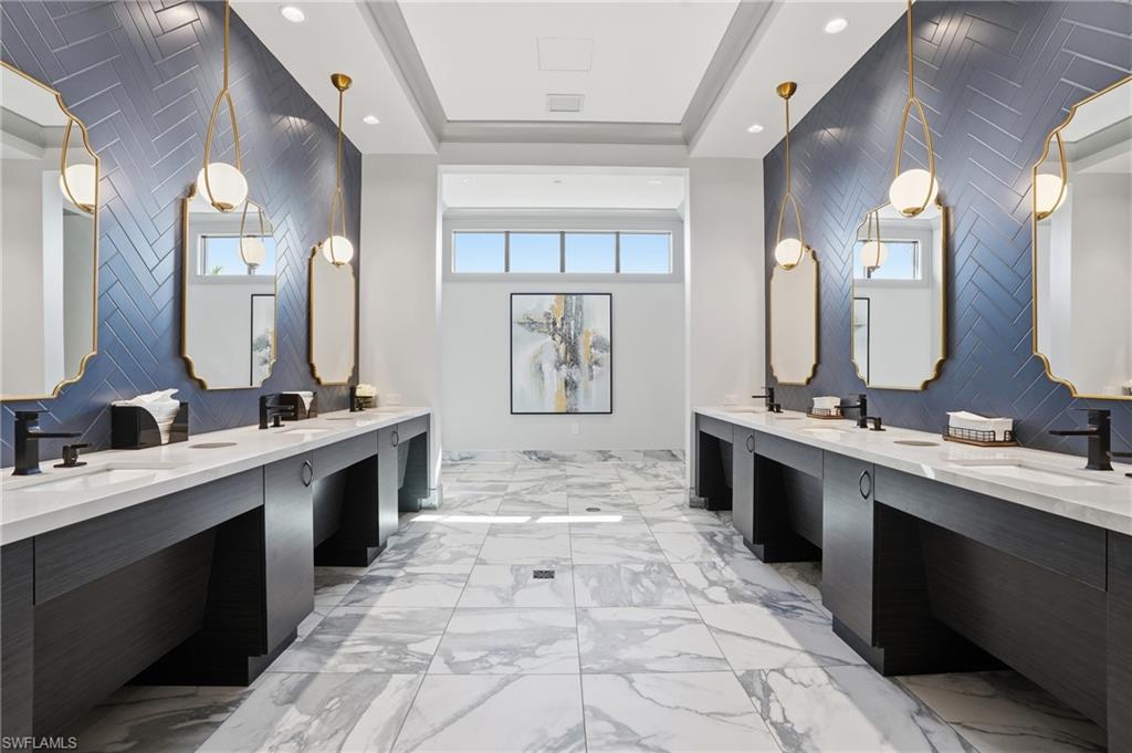 Dual vanities with white countertops, dark wood-finish cabinetry, and matte black fixtures