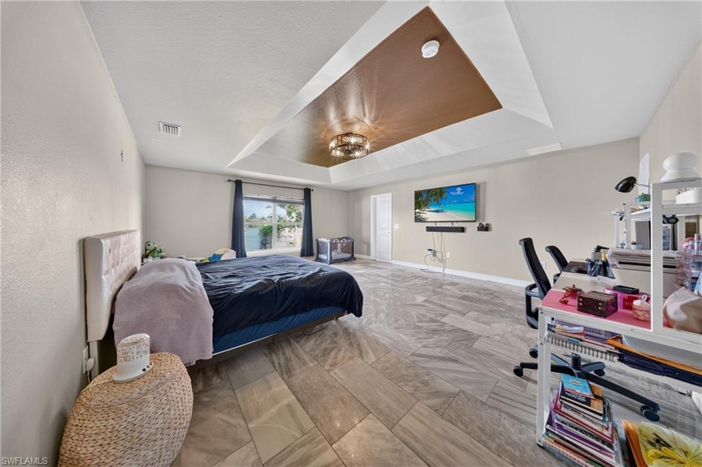 Tray ceiling with a decorative accent panel and a central light fixture