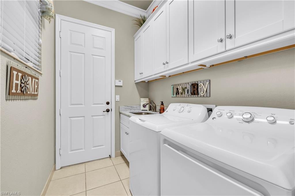 Laundry room with added cabinet for storage and laundry sink.