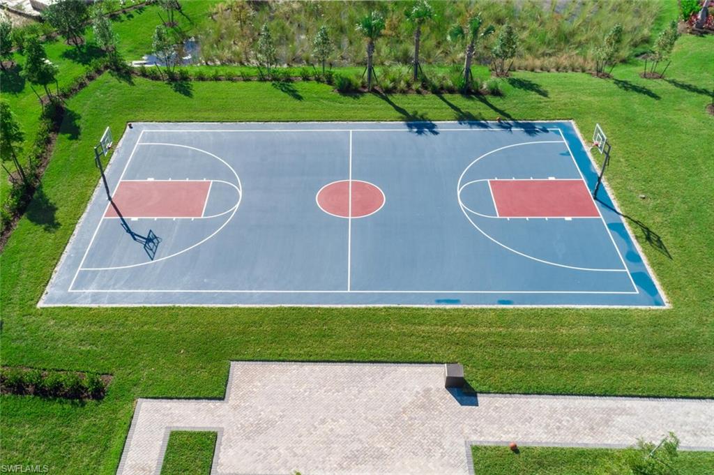 View of sport court featuring community basketball court and a lawn