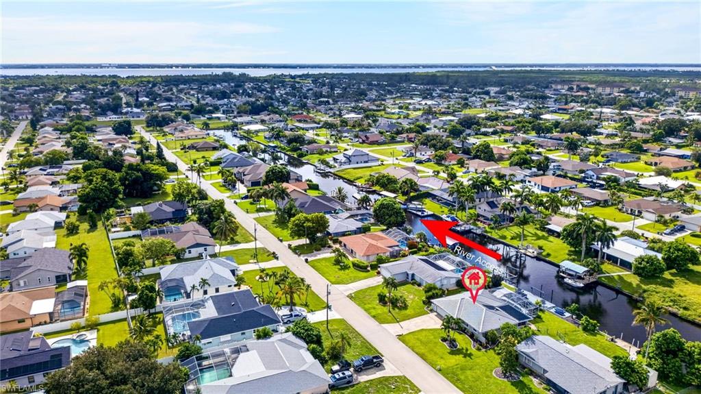 Aerial perspective showcasing a residential neighborhood with canal access