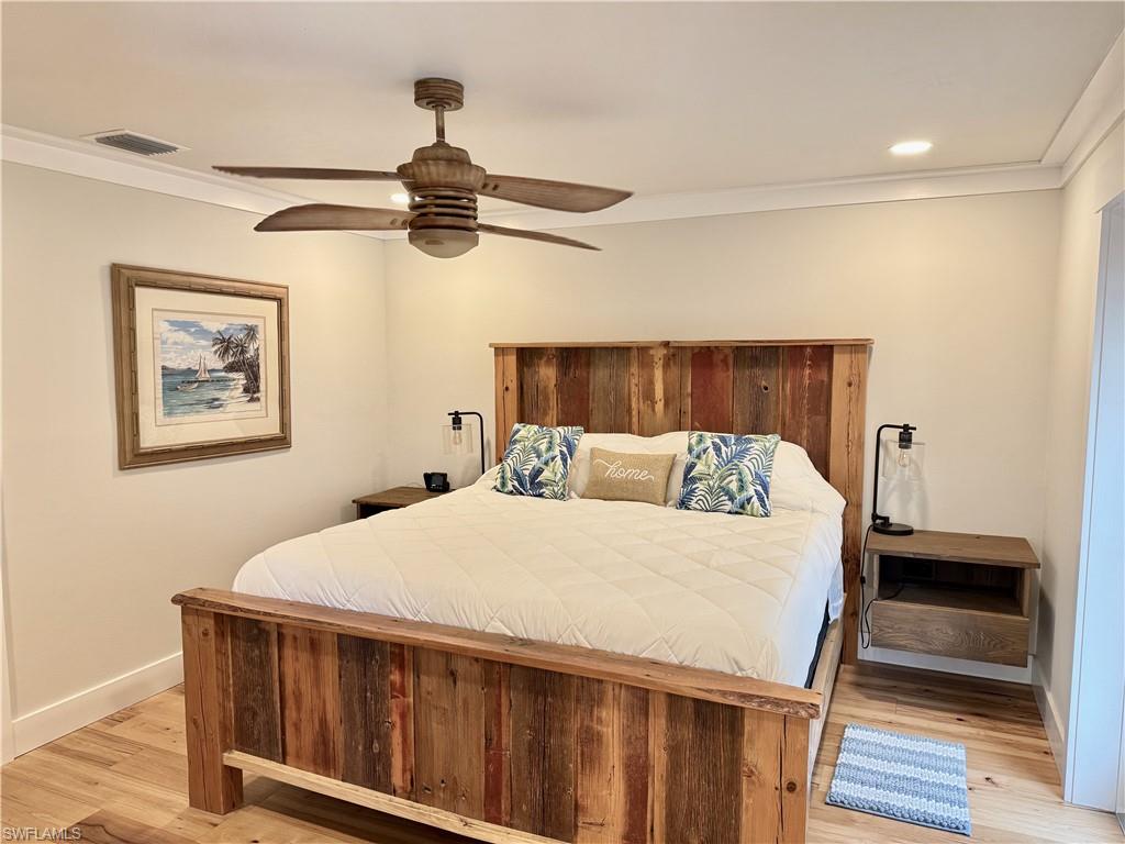 Wood-finish flooring, recessed lighting, crown molding, and a ceiling fan with light fixture