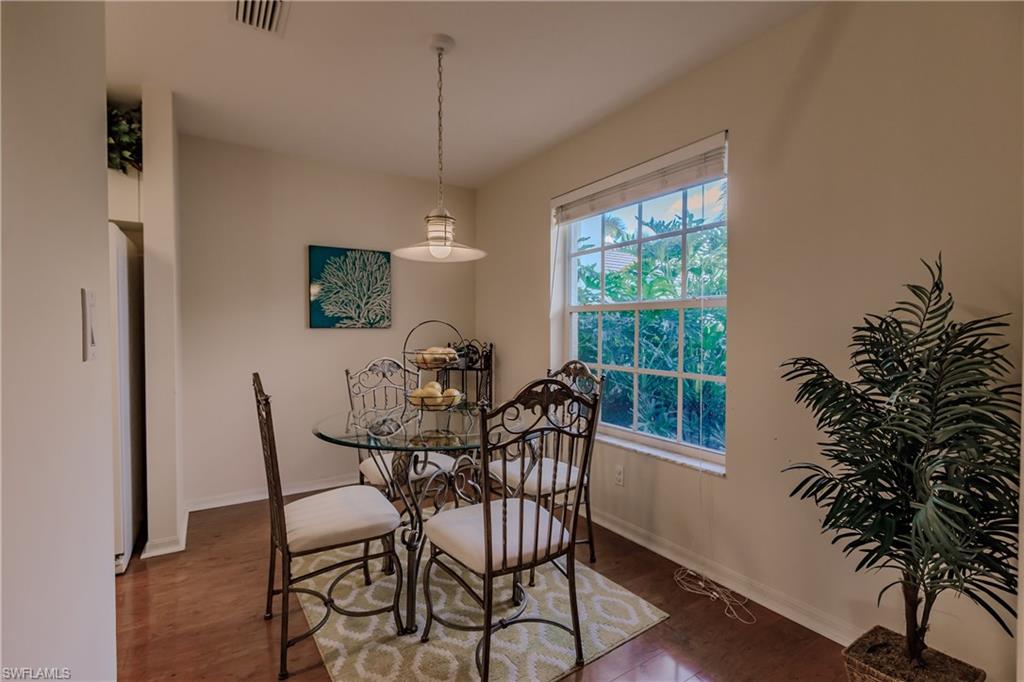 Dining room with dark hardwood / wood-style flooring