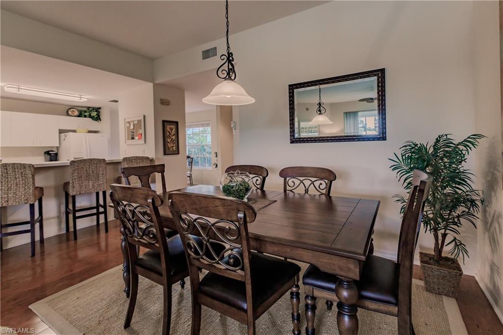 Dining room with dark hardwood / wood-style flooring
