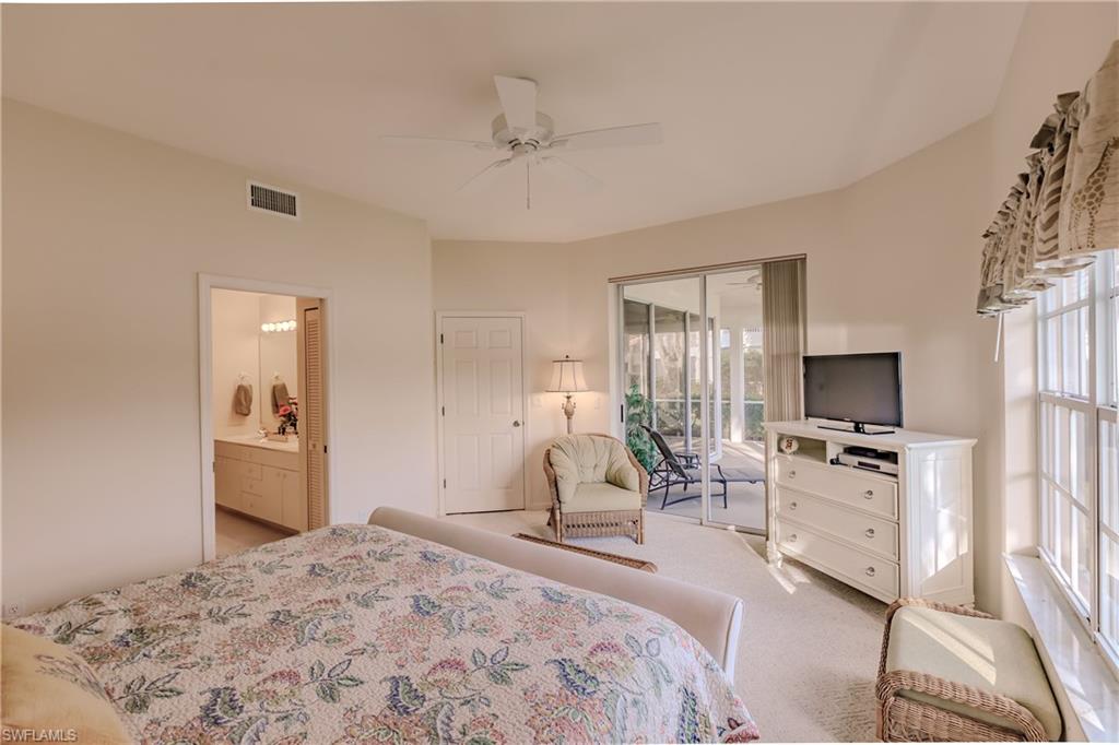 Bedroom with access to exterior, multiple windows, and ceiling fan